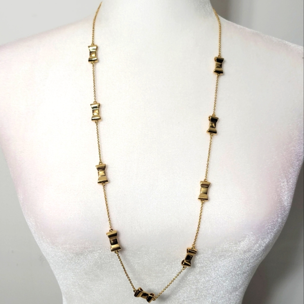 Kate Spade gold tone necklace with shiny bow charm